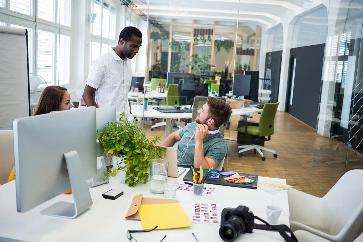 Office environment, people interacting with each other Office environment, people interacting with each other