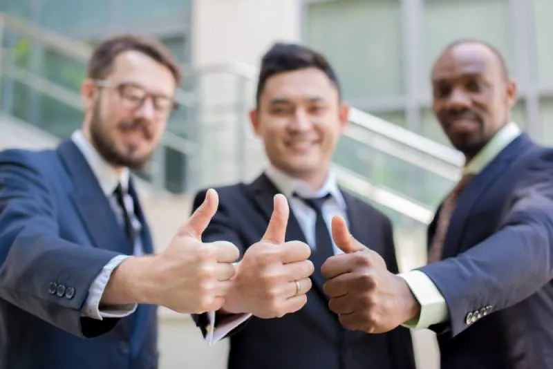 Close view of a hand holding a shiny award plaque against a blurred background, highlighting honor and achievement.