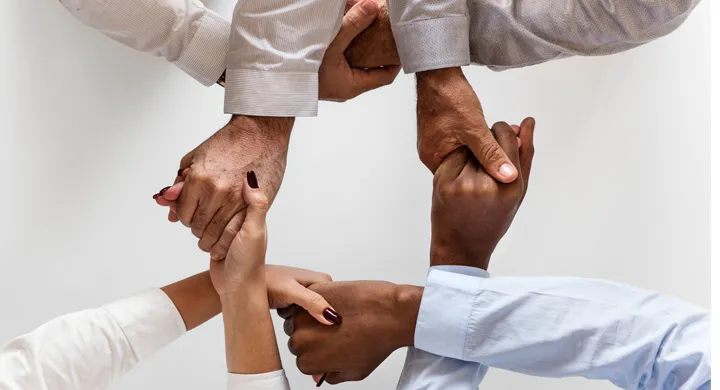 People holding hands showing unity