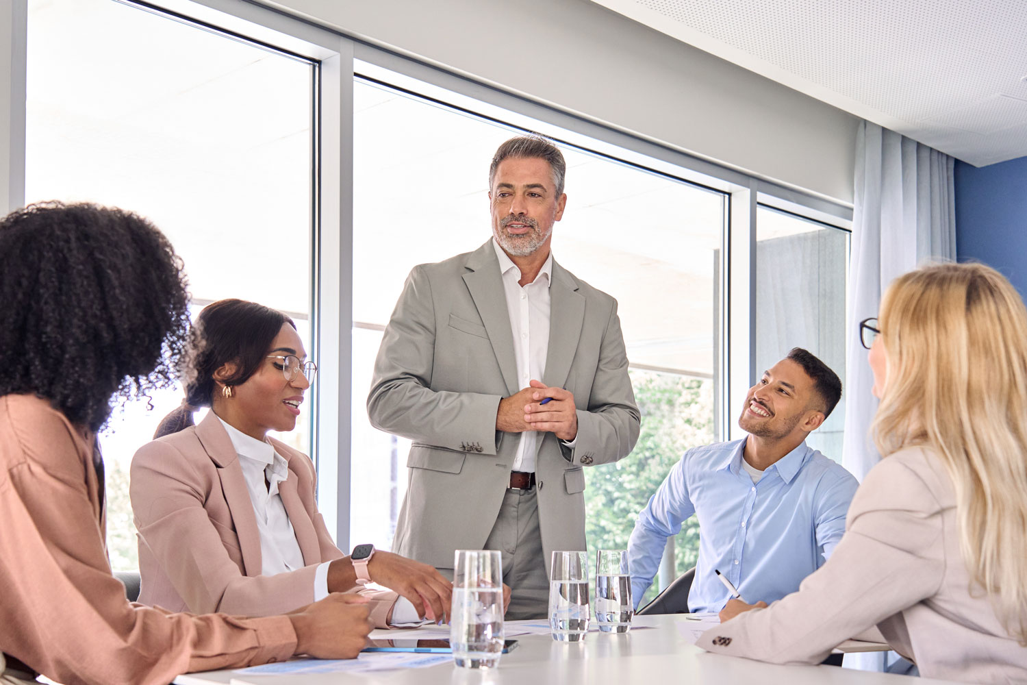 happy-leader-and-company-employees-at-business-meeting